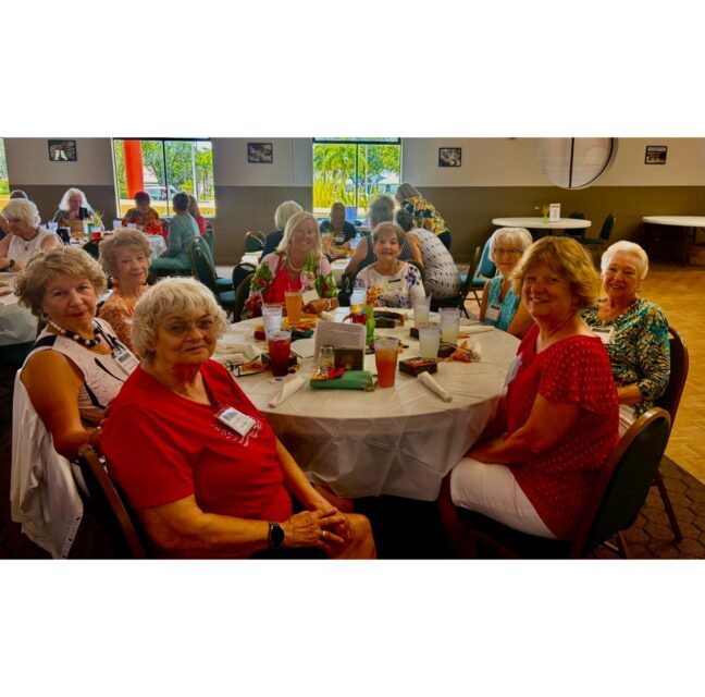 Arts & Crafts members seated around a table at the monthly luncheon