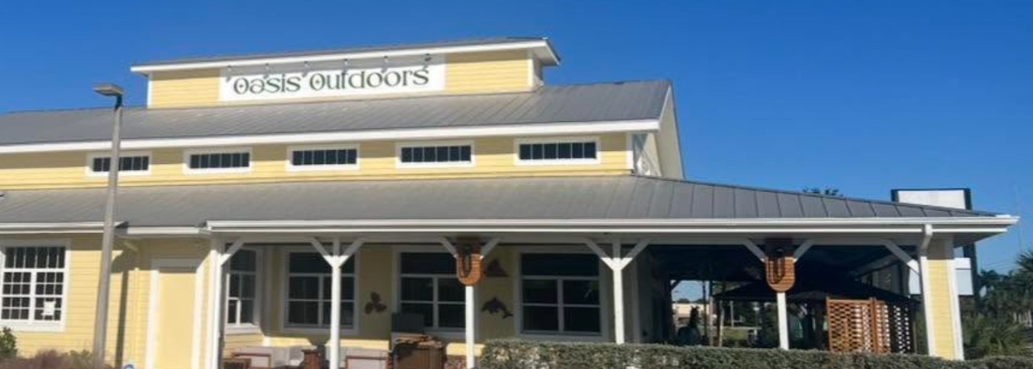 Yellow Oasis Outdoors building with its wraparound front porch on Hancock Bridge Parkway