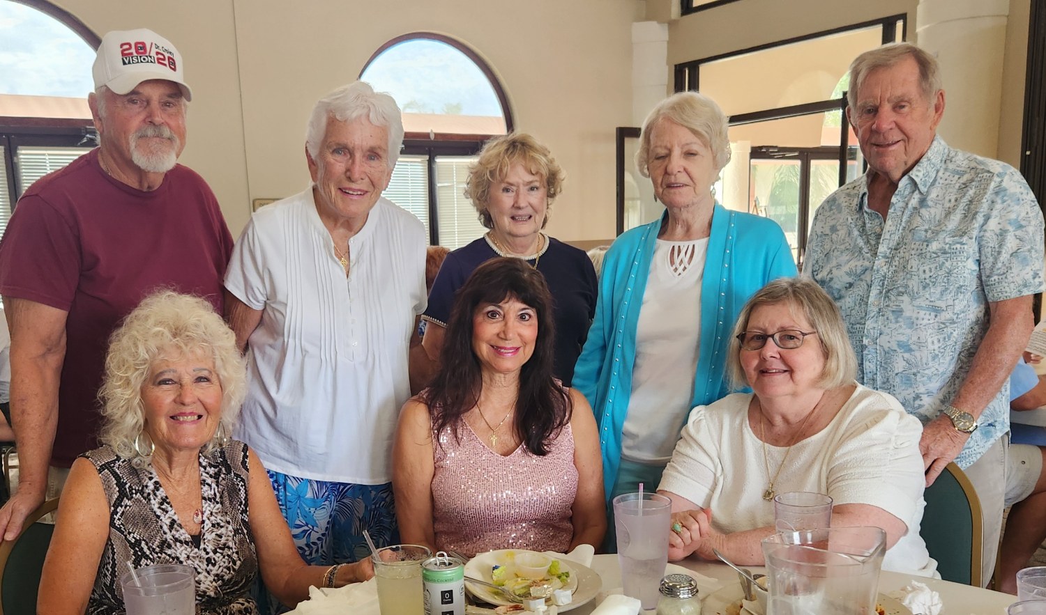 SunShine Singles group posing together around a restaurant table