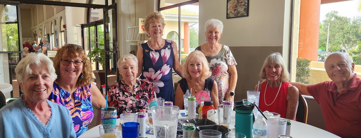 SunShine Singles gathered around a restaurant table for lunch
