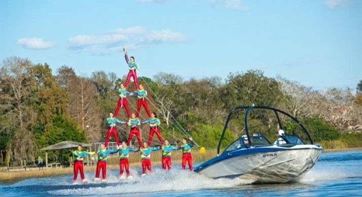 Cypress Gardens Water Ski Team forms a four-tier human pyramid behind a boat