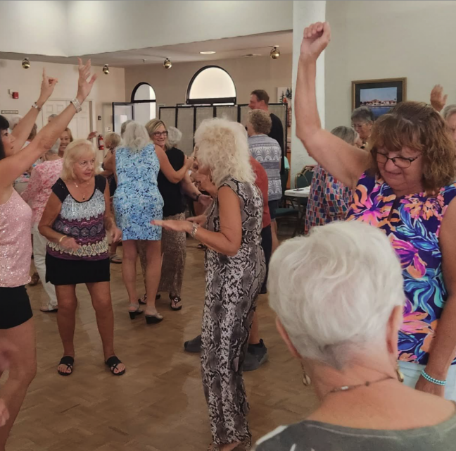 Sunshine Singles members dancing at a clubhouse party