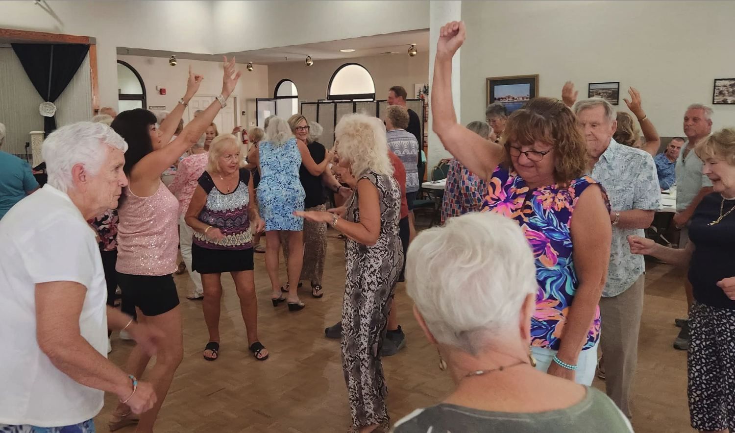 Sunshine Singles members dancing at a clubhouse party
