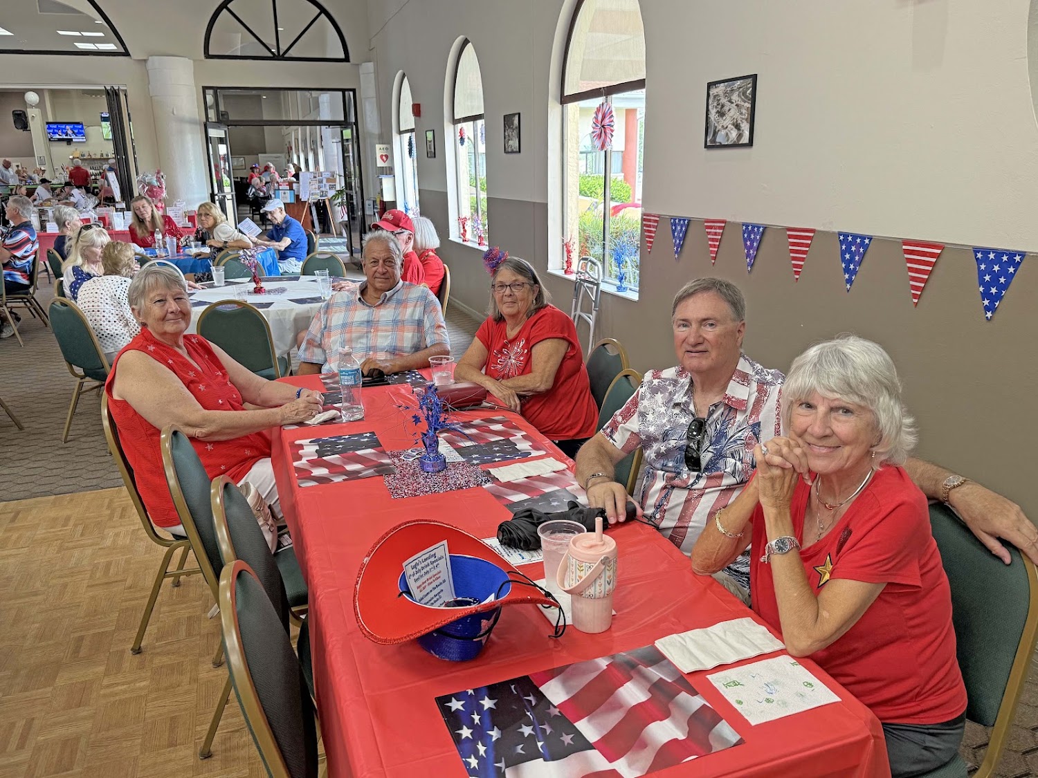 Clubhouse event room full of residents at a patriotic party