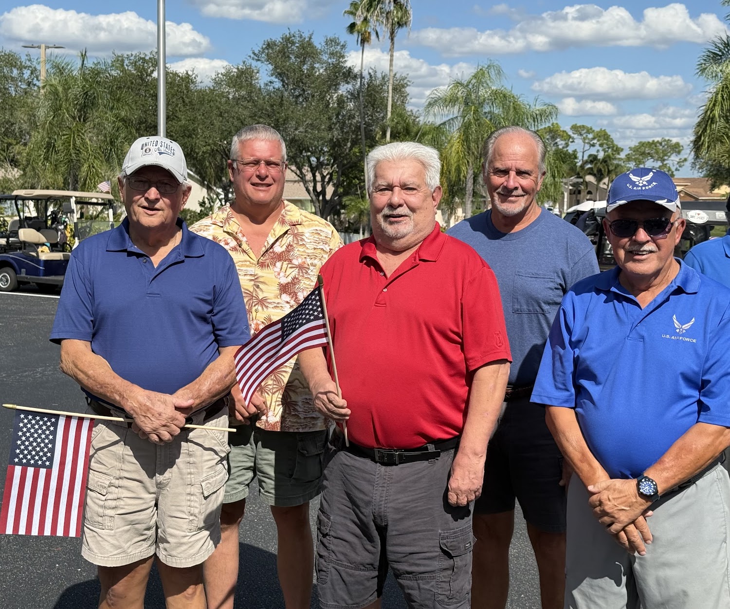 Sabal Springs Air Force veterans holding American flags outside the Clubhouse.