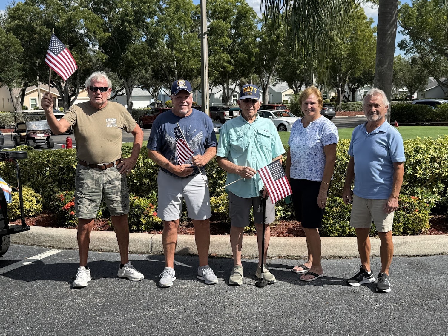 Sabal Springs Navy veterans with American flags outside the Clubhouse.