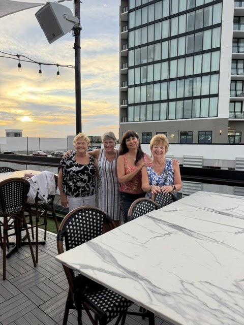 SunShine Singles members at a restaurant table at sunset.