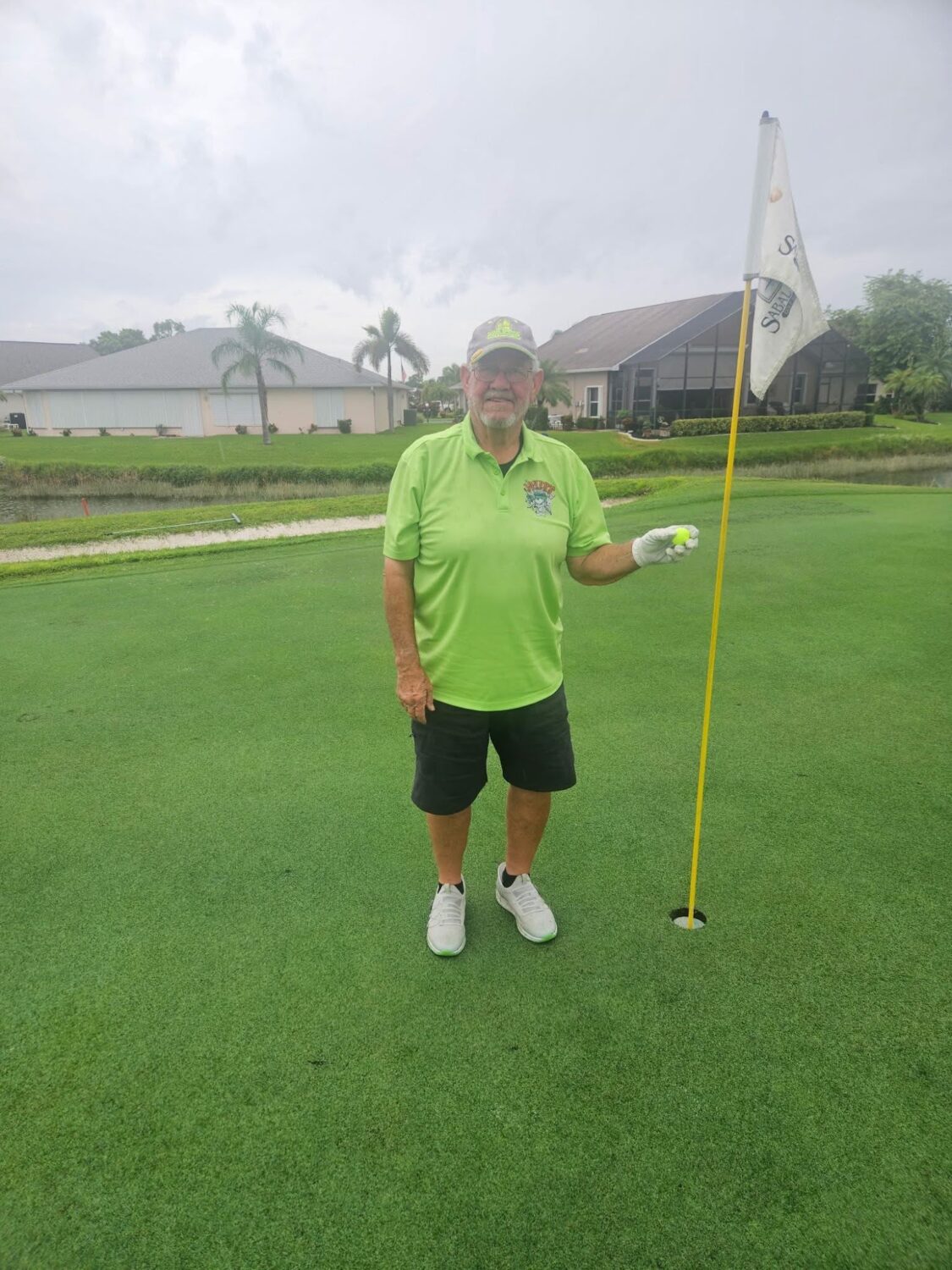Gary Clapp standing beside the flagstick on the ninth green.