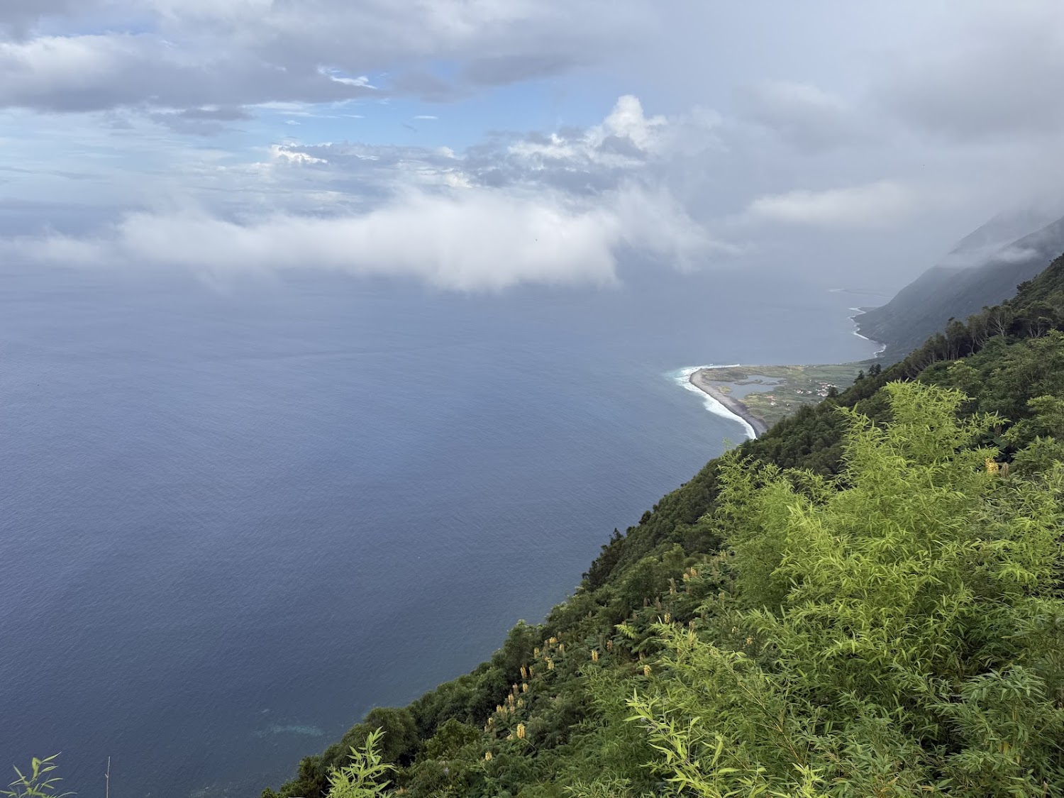 Cliffside view over the Atlantic with low clouds in the Azores.