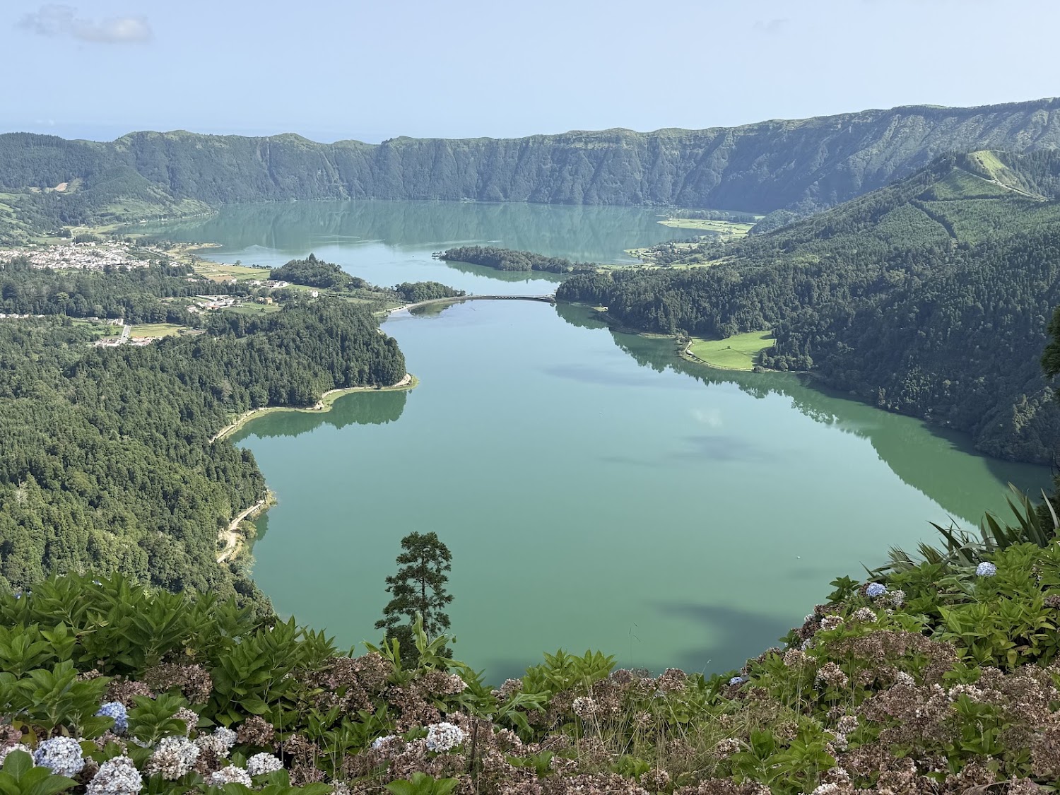 Green crater lake surrounded by hills at Sete Cidades.